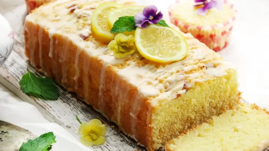  Saftiger Zitronen-Buttermilch-Kuchen mit frischer Glasur und Zitronenscheiben dekoriert.