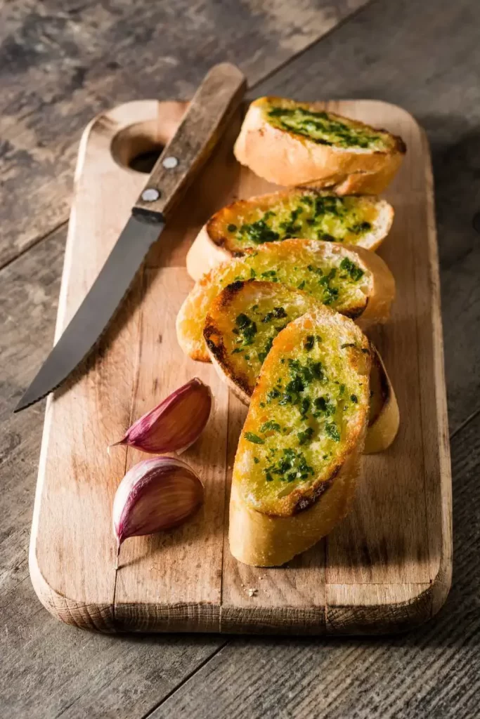 Omas Knoblauchbrot, frisch gebacken mit knuspriger Kruste und reichlich Butter und Kräutern